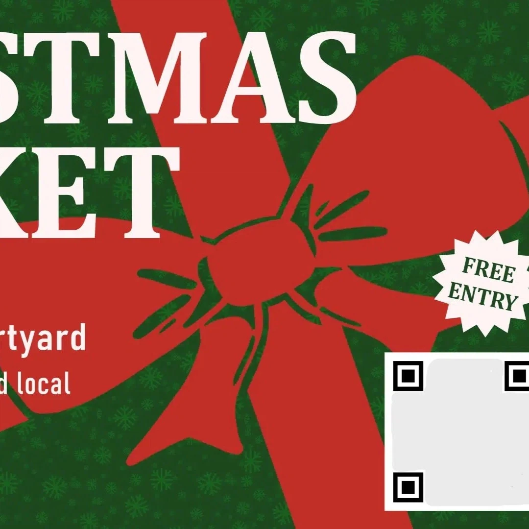A green poster with a red bow advertising a christmas market